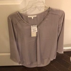 Beige/tan/grayish blouse with beaded neckline